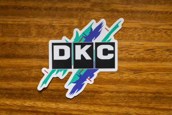 JDM DKC sticker on wooden table
