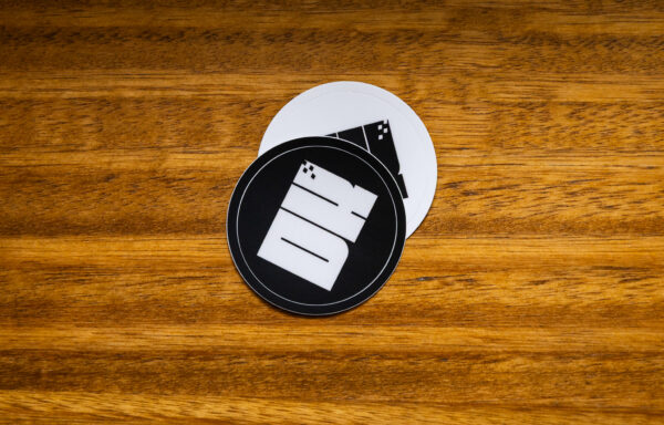 2025 DK logo black and white stickers on a wooden table