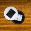2025 DK logo black and white stickers on a wooden table