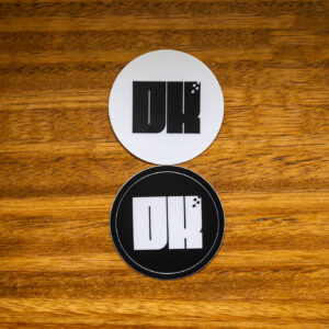 2025 DK logo black and white stickers on a wooden table