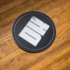 2025 DK logo black sticker on a wooden table